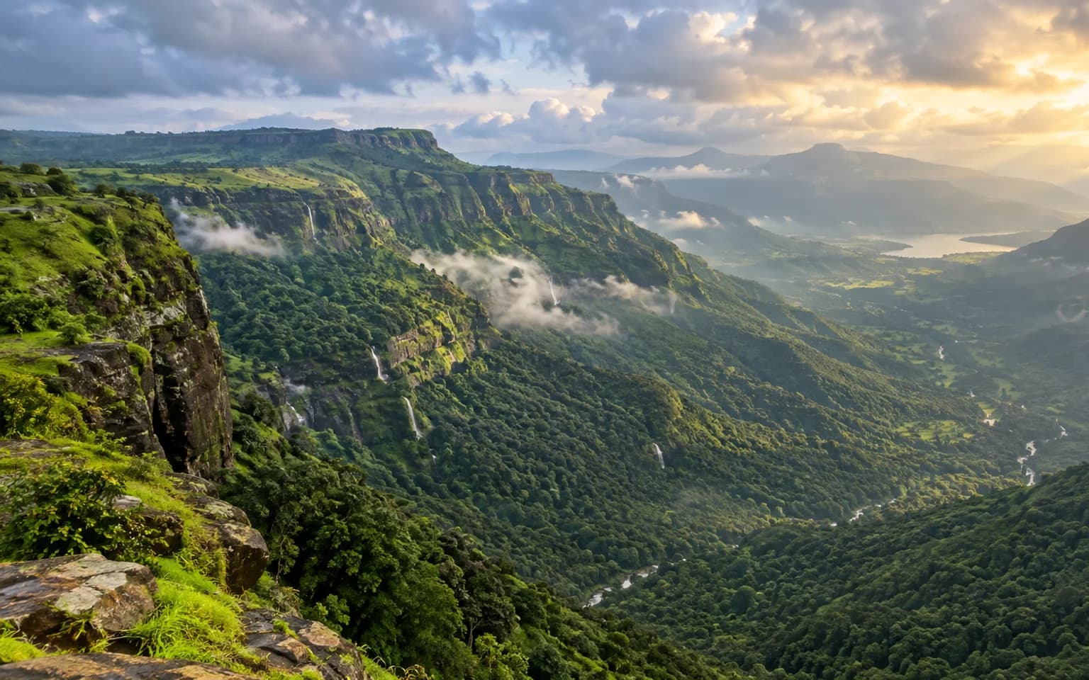 Green tableland cliffs and deep forested valley near Mahabaleshwar